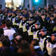 Policemen stand guard on the location where people were killed in a stampede incident during a New Year's celebration